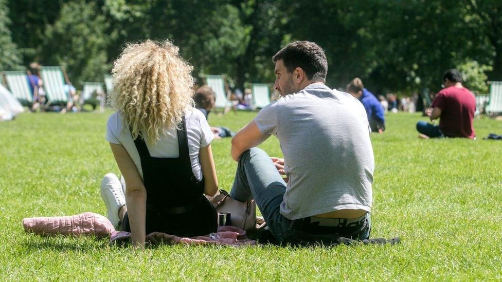 Two people relaxing in a park