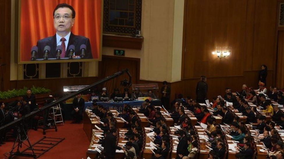 Chinese Premier Li Keqiang is shown on a giant screen as he delivers his speech at the National People's Congress. Photo: 5 March 2016