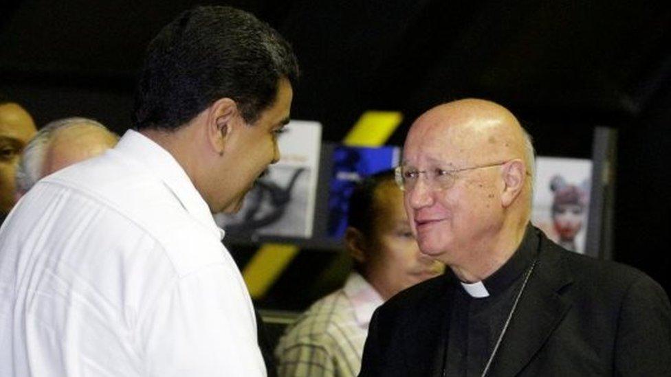 Venezuela's President Nicolas Maduro (C) shakes hands with Claudio Maria Celli (R), Vatican's representative, as he arrives for a political meeting between government and opposition