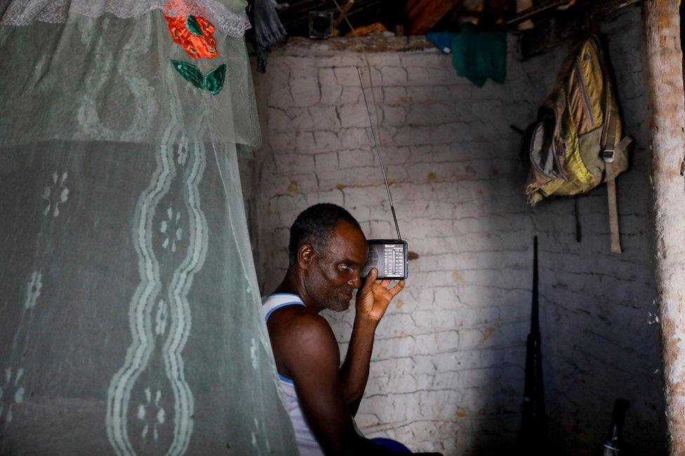 Fisherman Jose da Cruz listening to his radio