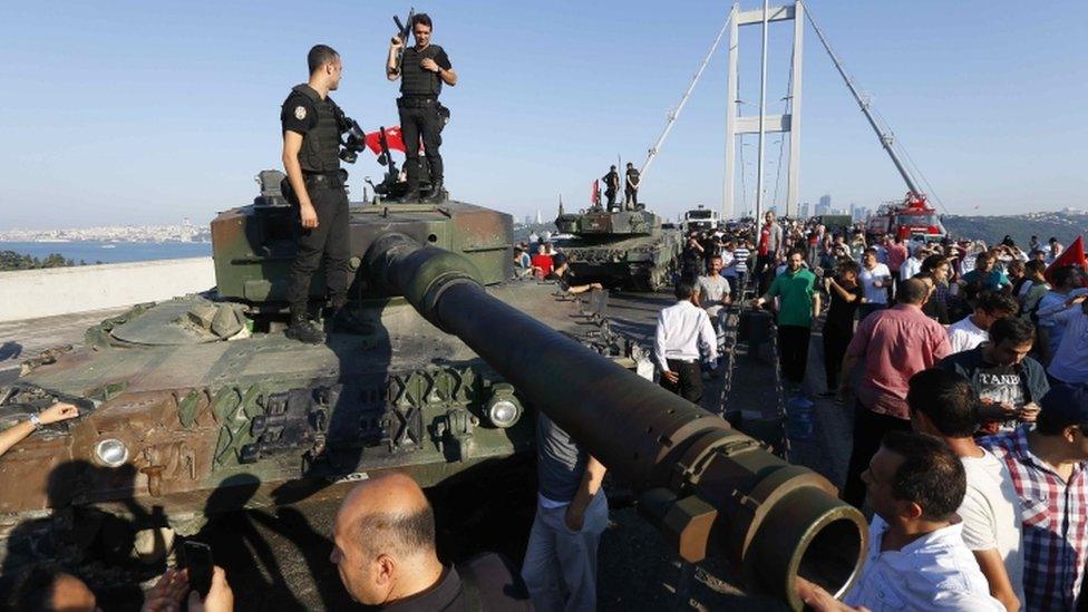 Policemen standings on a military vehicle on the Bosphorus Bridge in Istanbul, Turkey