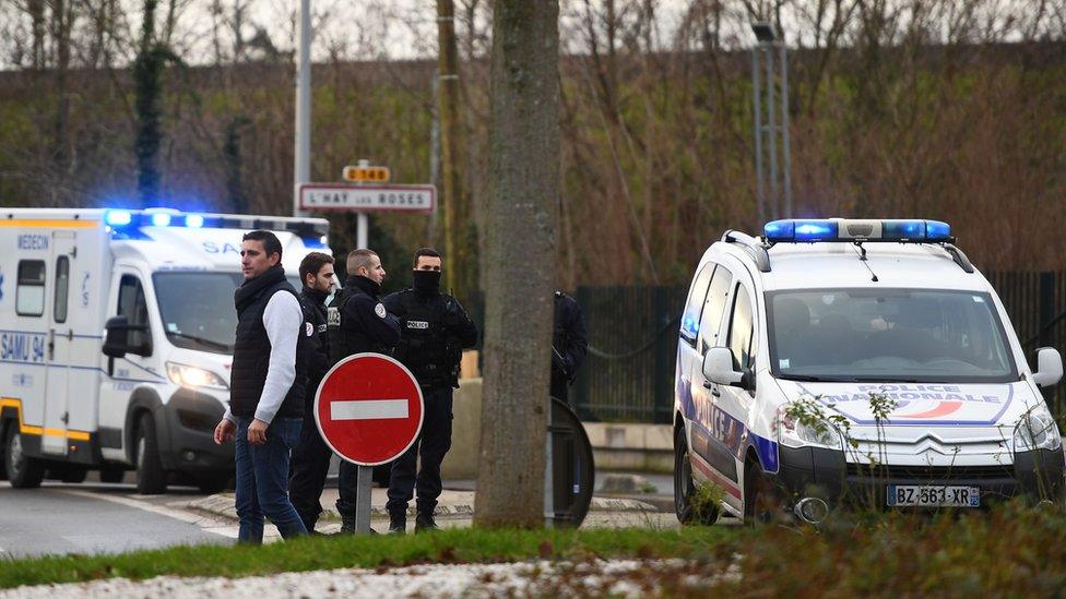 Police stand near a park in the south of Paris" suburban city of Villejuif