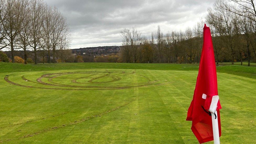 Tyre marks on golf green