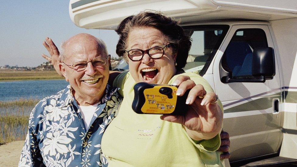 Couple holding a disposable camera