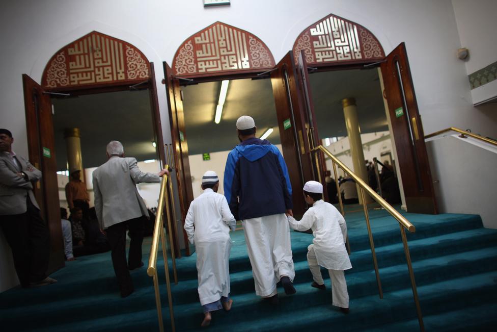 Muslim men and boys arrive to pray before Iftar, the evening meal in the Muslim holy month of Ramadan at the London Muslim Centre