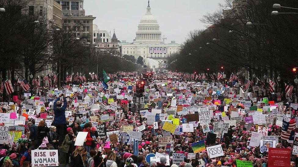 Protesters walk up Pennsylvania Avenue during the Women's March on Washington, with the U.S. Capitol in the background, on January 21, 2017