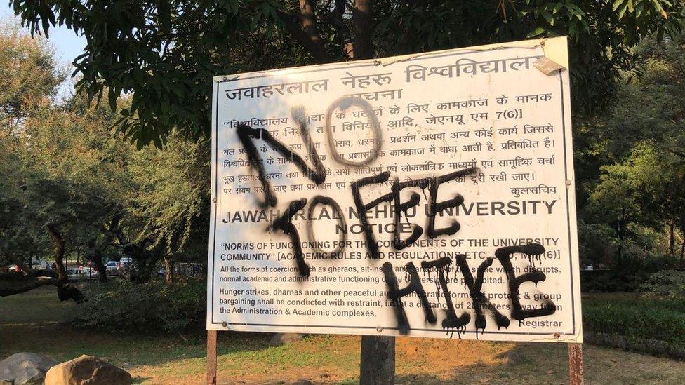 Sign with No Fee Hike in graffiti