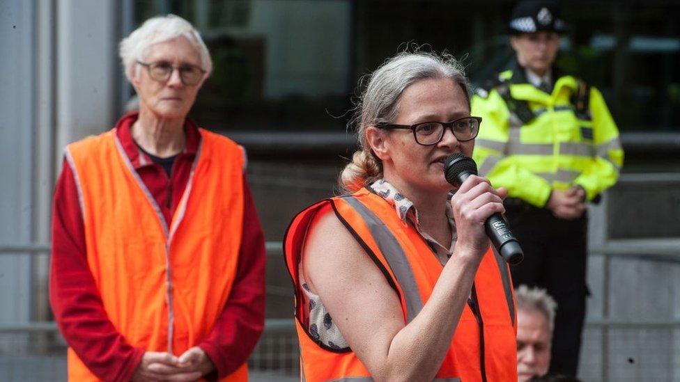 Judy Bruce listening to a speaker at a protest