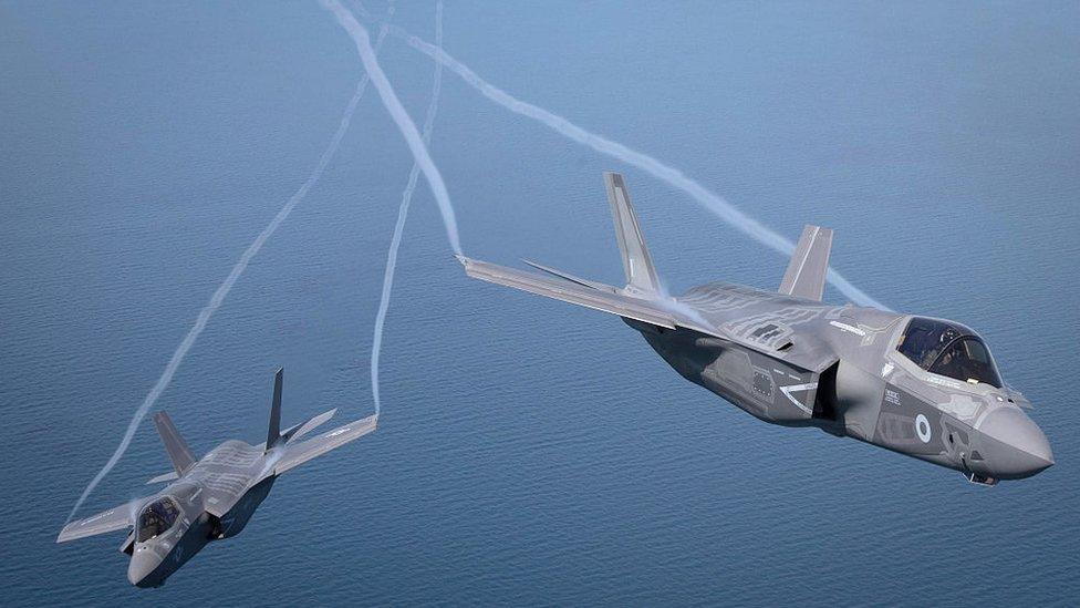 The first of Britain's new supersonic 'stealth' strike fighters accompanied by a United States Marine Corps F-35B aircraft, flies over the North Sea