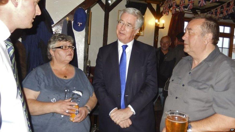 UK Defence Secretary Michael Fallon (second right) speaks to Member of the Legislative Assembly Michael Poole (left) in Stanley 16/02/2016