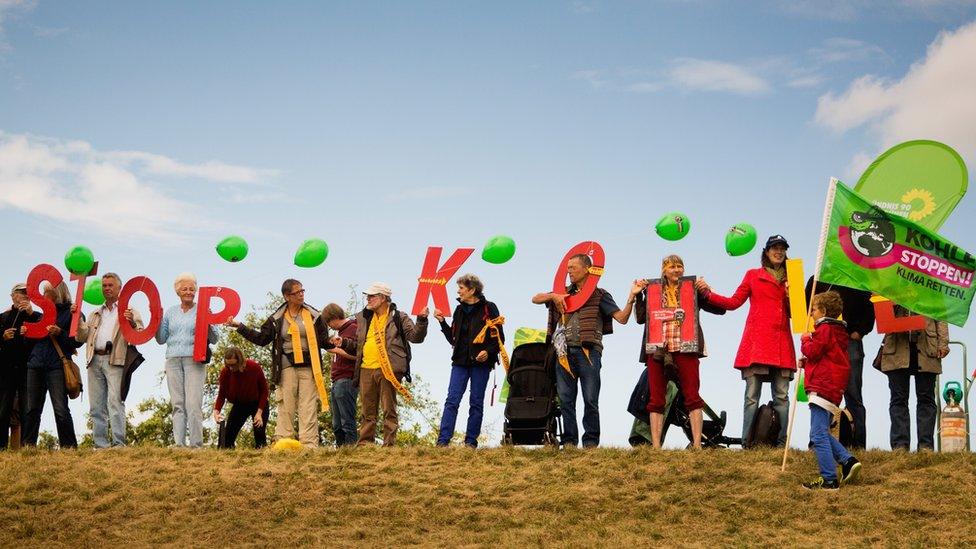 Activists hold letters "Stop Kohle" (Stop Coal) against expansion of open-cast coal mine near Gross Gastrose, Germany. 23 August 2014