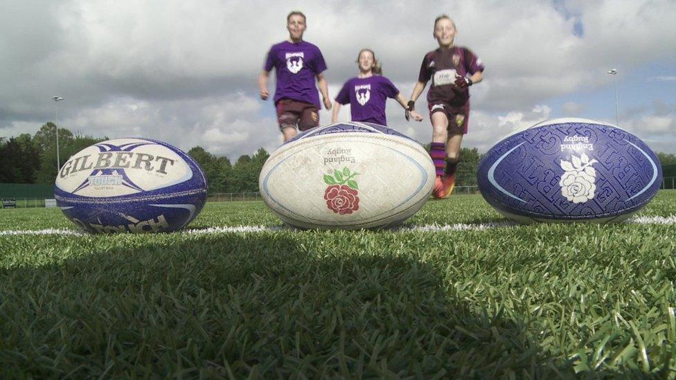 kids run towards rugby ball