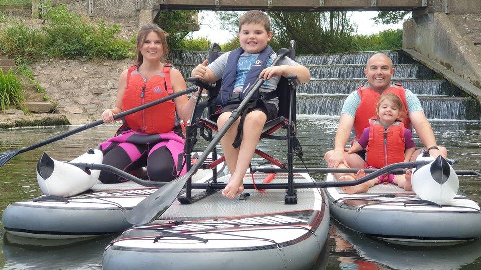 Oscar Arnold and his family paddle boarding