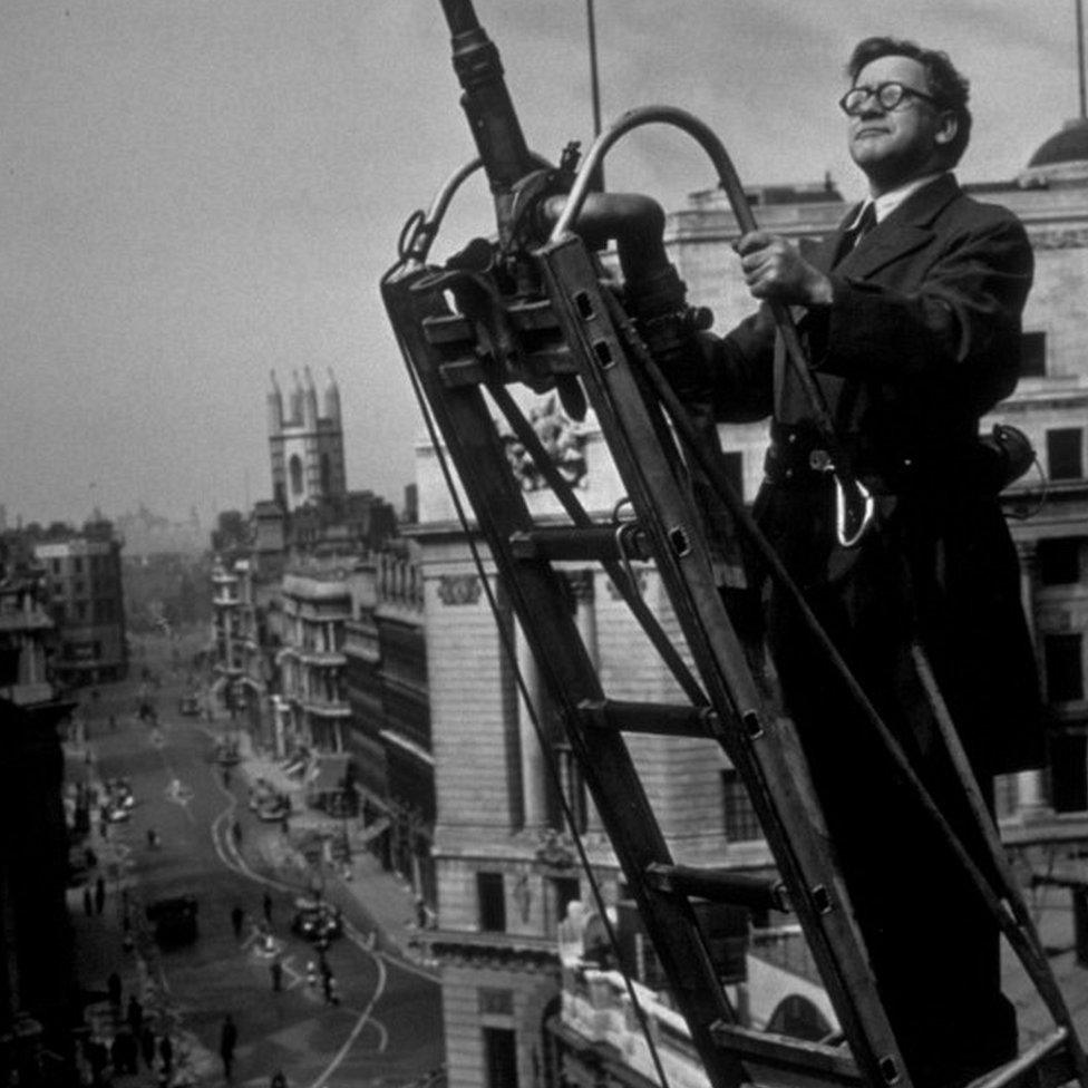 1942: The Minister of Home Security, Herbert Morrison, at the top of a ladder during the demonstration of London's highest fire turntable.