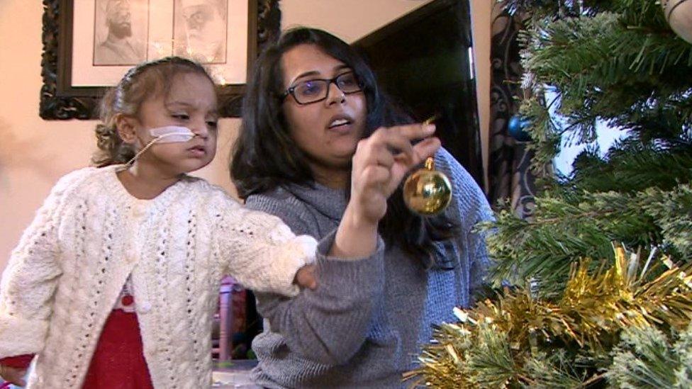 Anaya Kandola and her mum, Joety, decorate the family Christmas tree