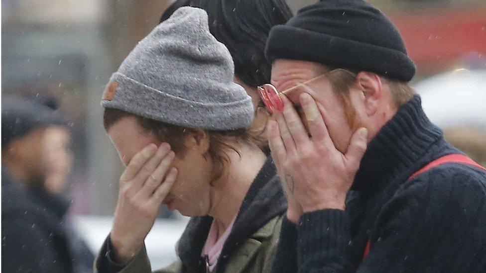 Members of the band Eagles of Death Metal, Jesse Hughes, right, and Julian Dorio pay their respects to 89 victims who died at the Bataclan concert hall in Paris