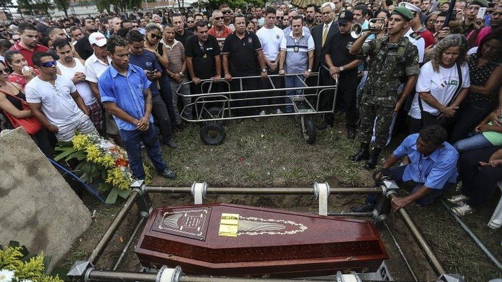 A large crowd of mourners attend the funeral of policeman Mario Marcelo Albuquerque, who was killed in the line of duty in Serra, Espirito Santo, Brazil, 8 February 2017.