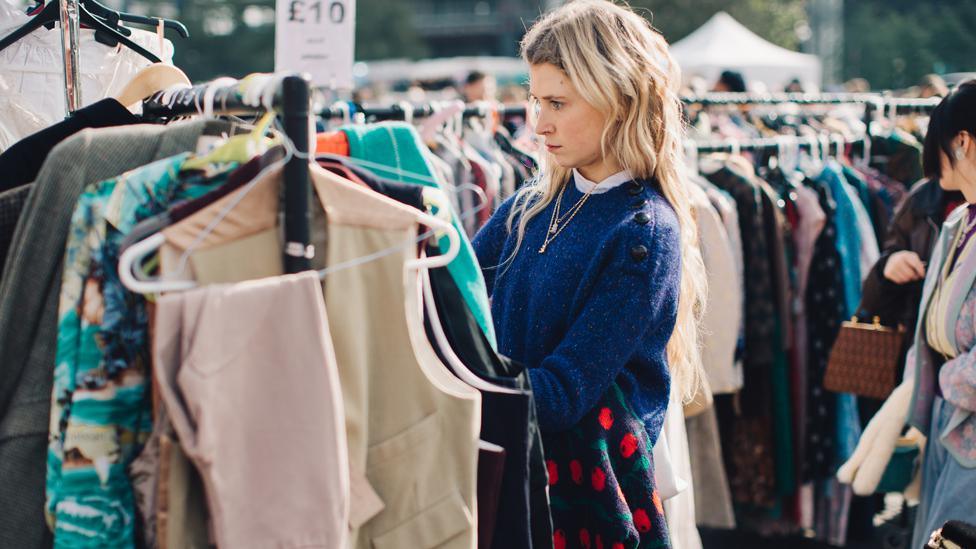 Woman browsing clothes on a rack