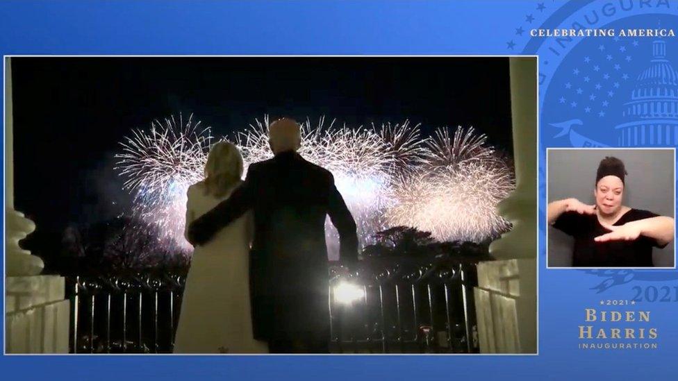 President Joe Biden and first lady Jill Biden watch fireworks from the balcony of the White House, at the "Celebrating America" event in this still image from video