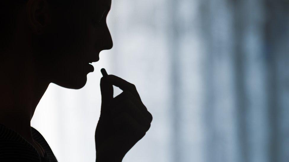 Woman taking a pill