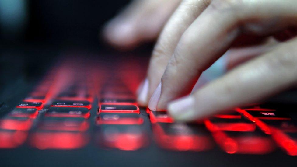 Fingers typing on a computer keyboard