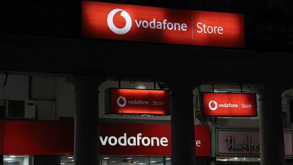 Billboards of Vodafone telecom can be seen outside their outlet in Delhi