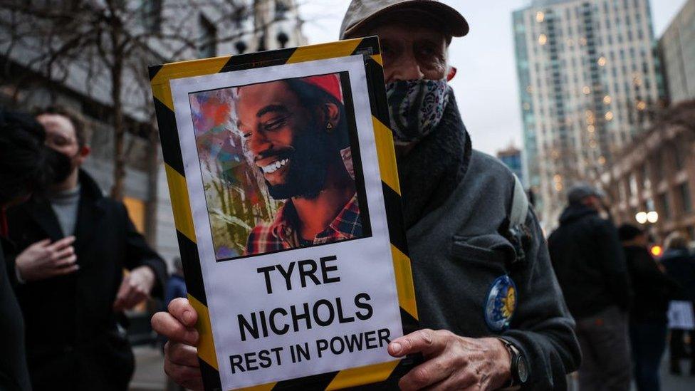 Photo of protestor in Oakland holding sign that says 'Tyre Nichols Rest in Power'