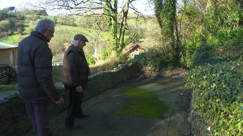 Men inspecting sewage