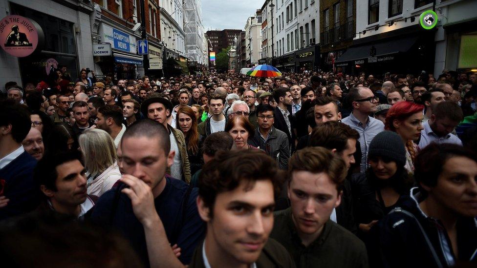 People gather in Soho, London