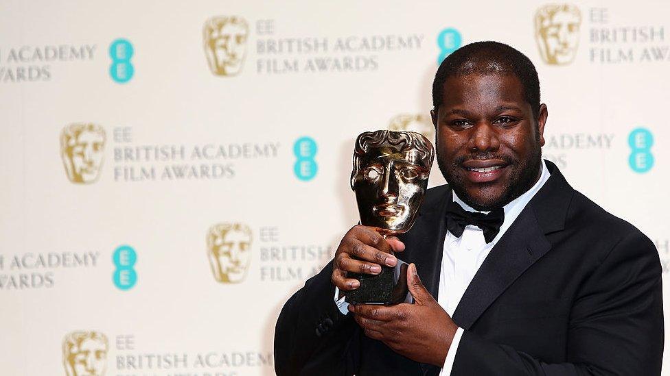 Steve McQueen holding a BAFTA Award