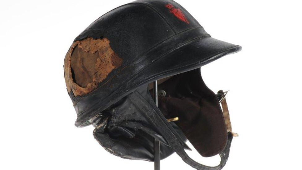 A Royal Ulster Constabulary helmet from the 1970s damaged by a petrol bomb during a riot in Londonderry