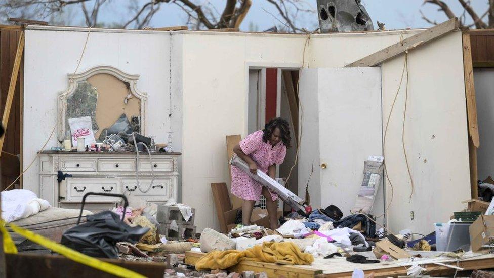 Woman sorting the remains of her home after the US tornado