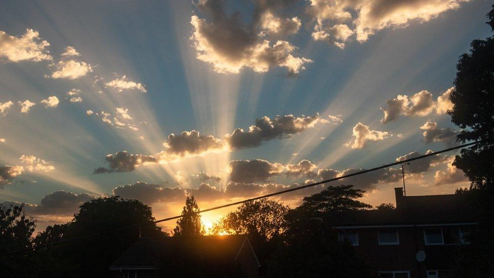 Crepuscular rays light up the sky