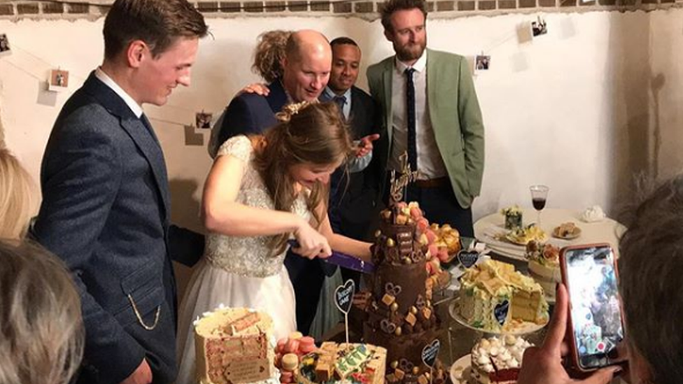 Martha cutting the cake at her wedding