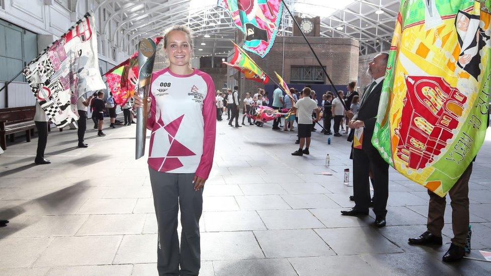 Baton bearer Emily Defroand holds the Queen's Baton during the Birmingham 2022 Queen's Baton Relay on a visit to The London Cruise Terminal