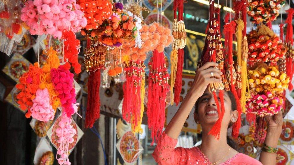 many rakhi hanging in front of a shop