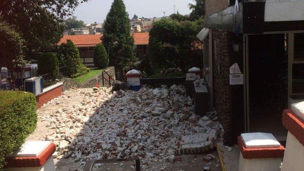 The collapsed outer wall of a classroom