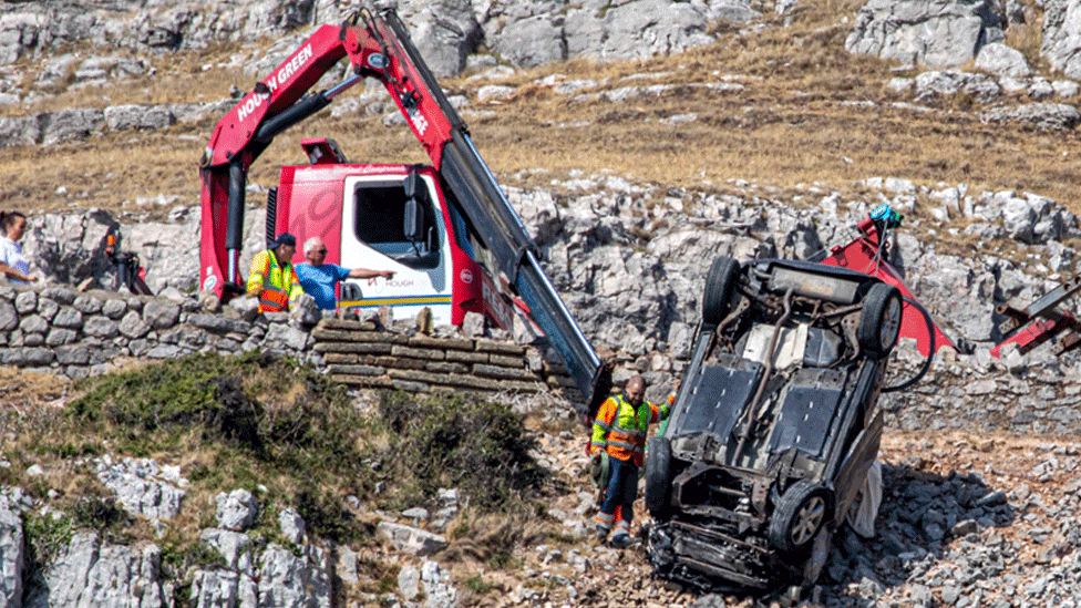 Upturned car on the side of a steep slope