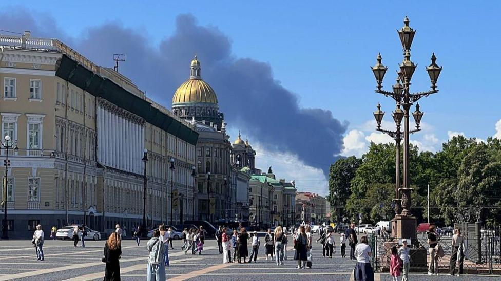 Smoke rises near St Petersburg after a Ukrainian drone strike during Russia's economic forum