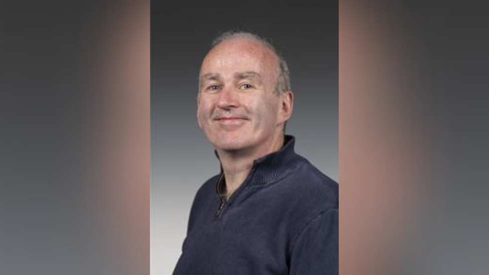 A man in a blue sweater