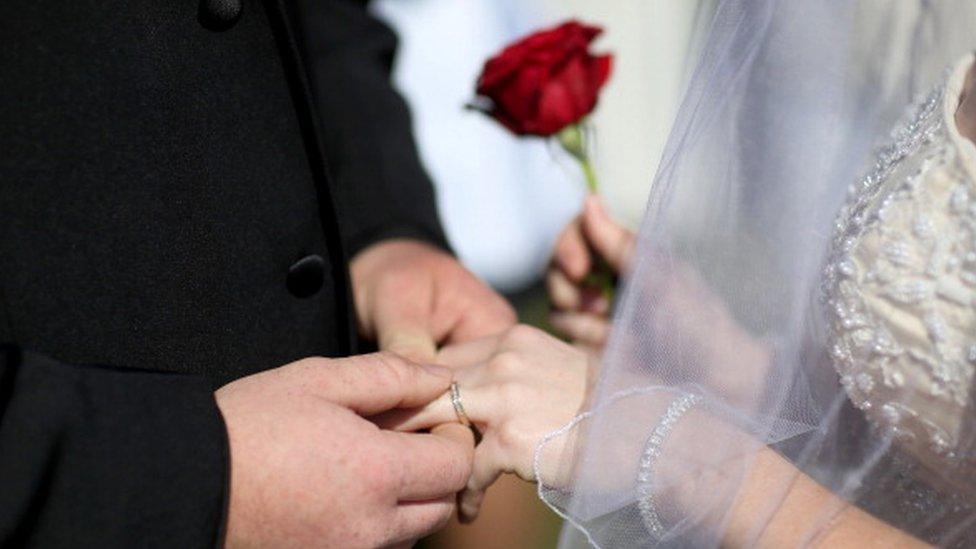 Bride and groom exchange rings