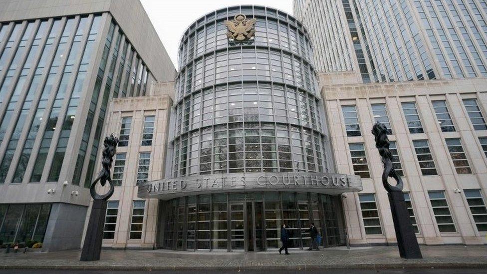 People walk past the Federal Courthouse in Brooklyn where the Fifa trial is talking place on November 13, 2017 in New York