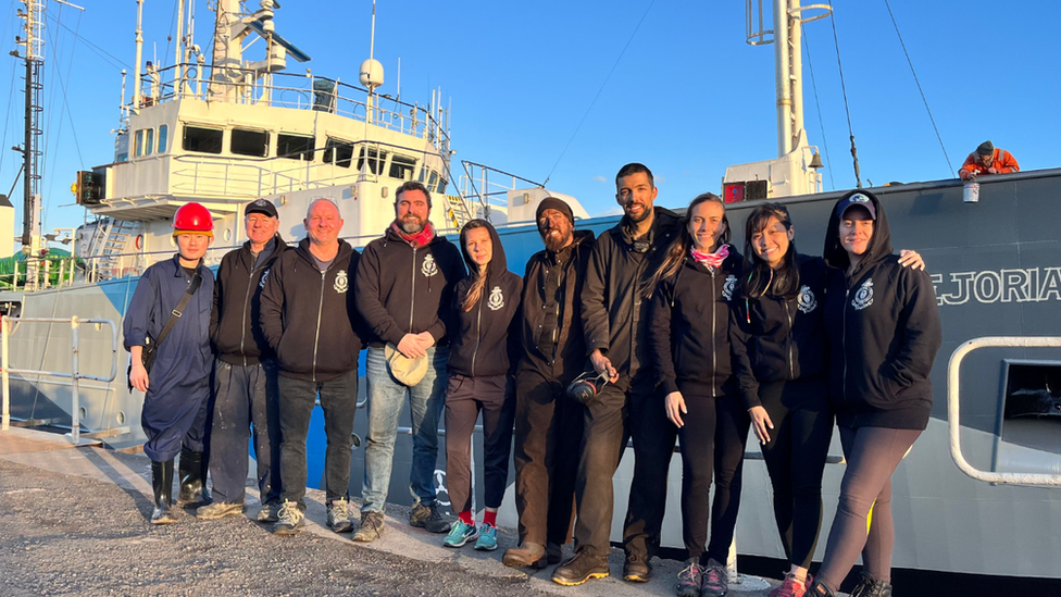 Crew alongside the ship