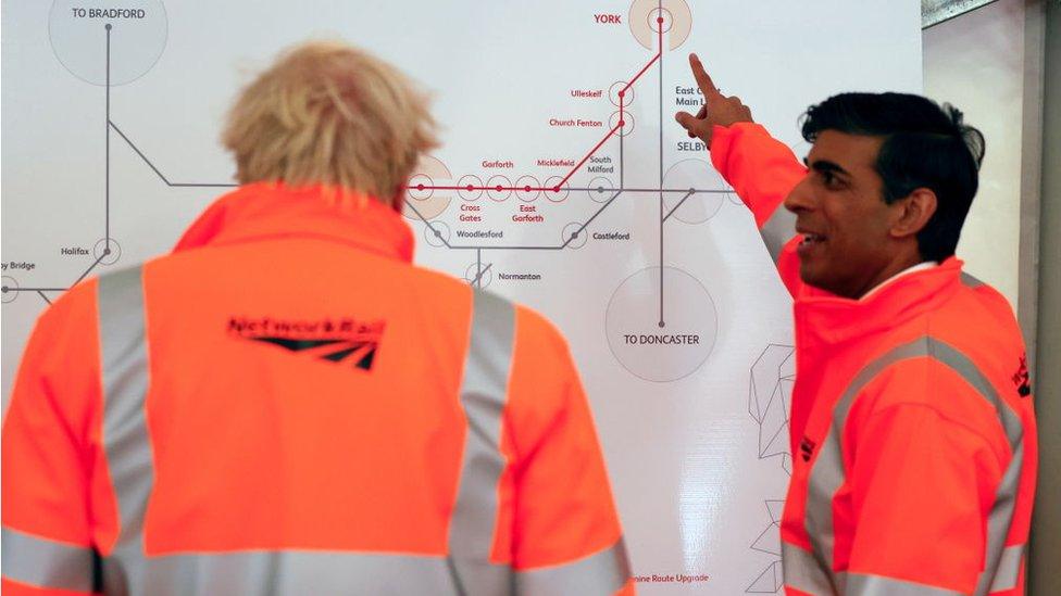 Boris Johnson and Rishi Sunak look a train map in Network Rail hi vis gear