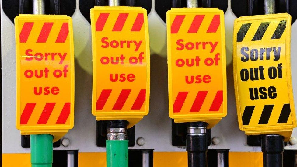 An "out of use" sign covers fuel pumps at a petrol station in Birkenhead, northwest England on September 27, 2021