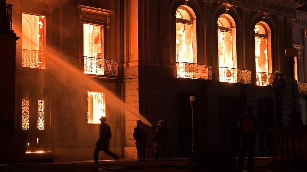 Firefighters work as a massive fire engulfs the National Museum in Rio de Janeiro on 2 September 2018