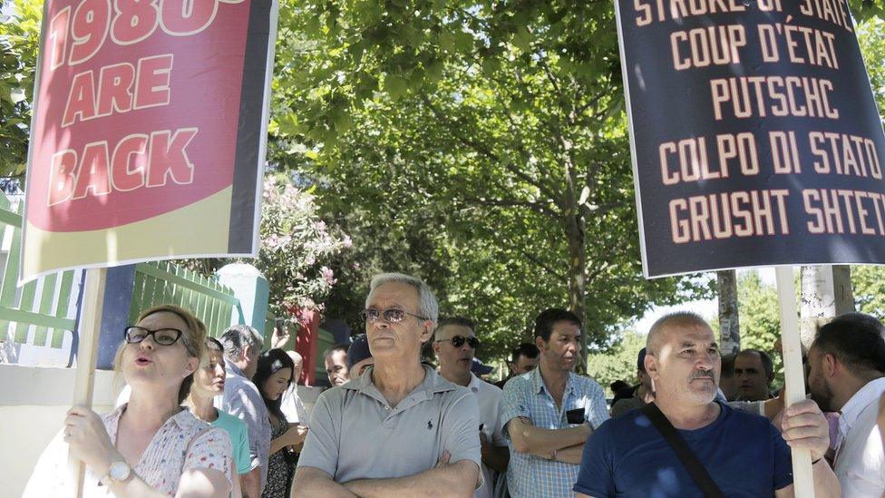 Supporters of the opposition protest outside a polling station in Tirana, Albania