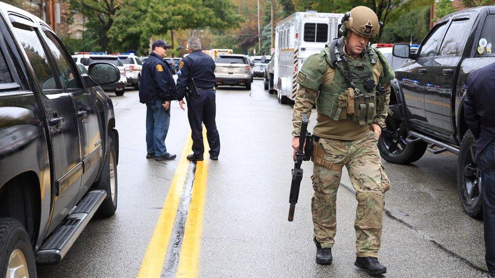 A Swat officer and police officers arrive at the scene of a suspected religiously-motivated attack on a synagogue in Pittsburgh, Pennsylvania, 27 October 2018