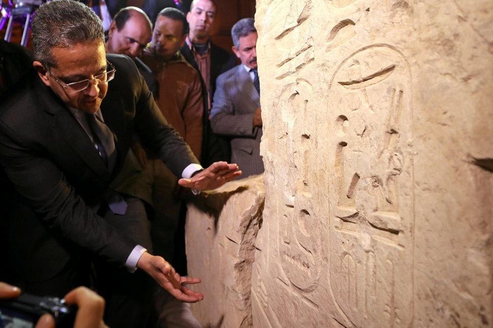 Egyptian Minister of Antiquities Khaled Al-Anani stands beside the colossus explaining new evidence pointing to it depicting Psamtek I in Cairo