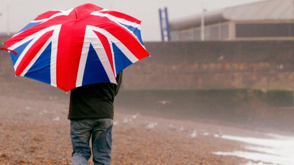 A man with a Union Jack umbrella